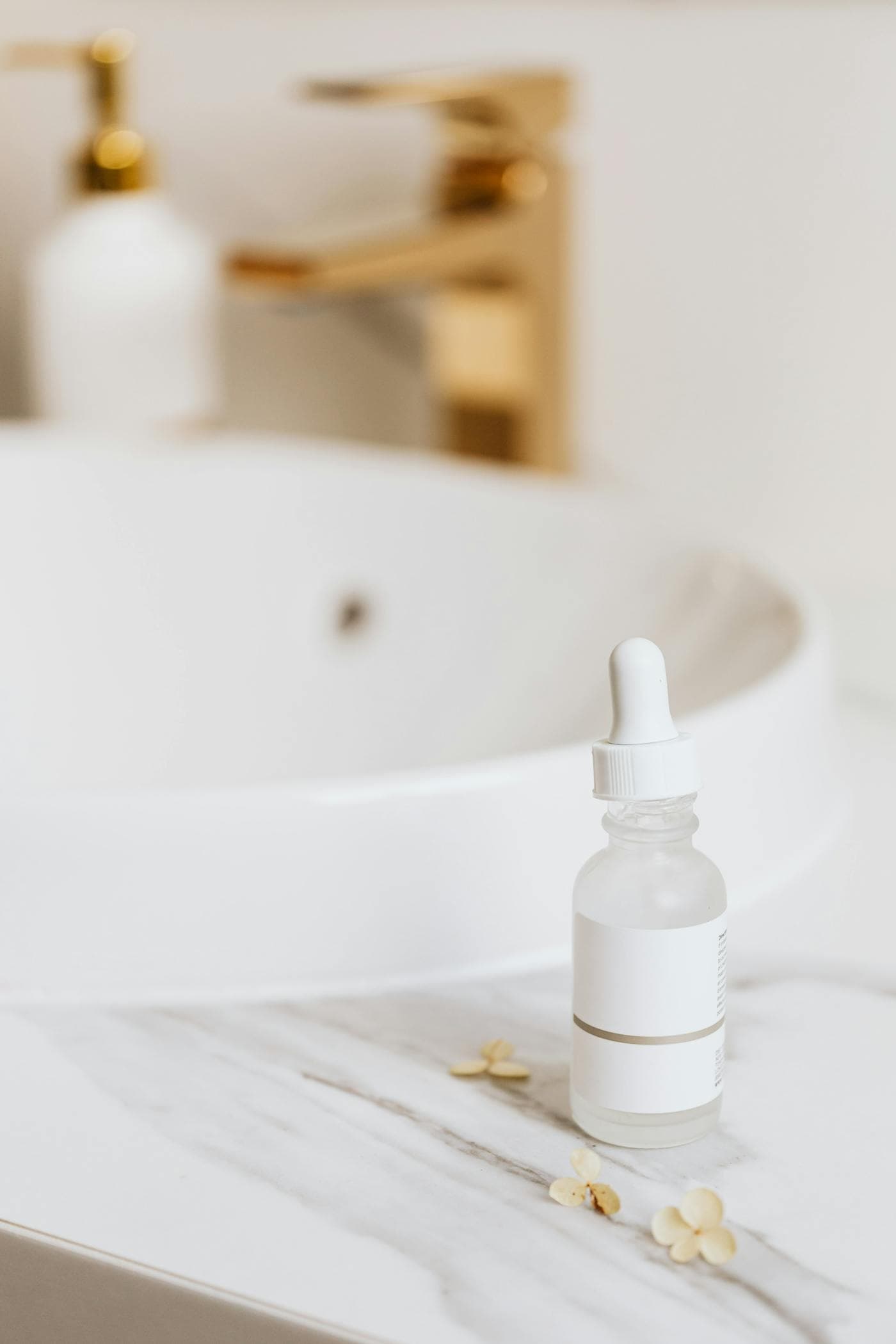 Close-up of a skincare serum dropper on a neutral editorial surface